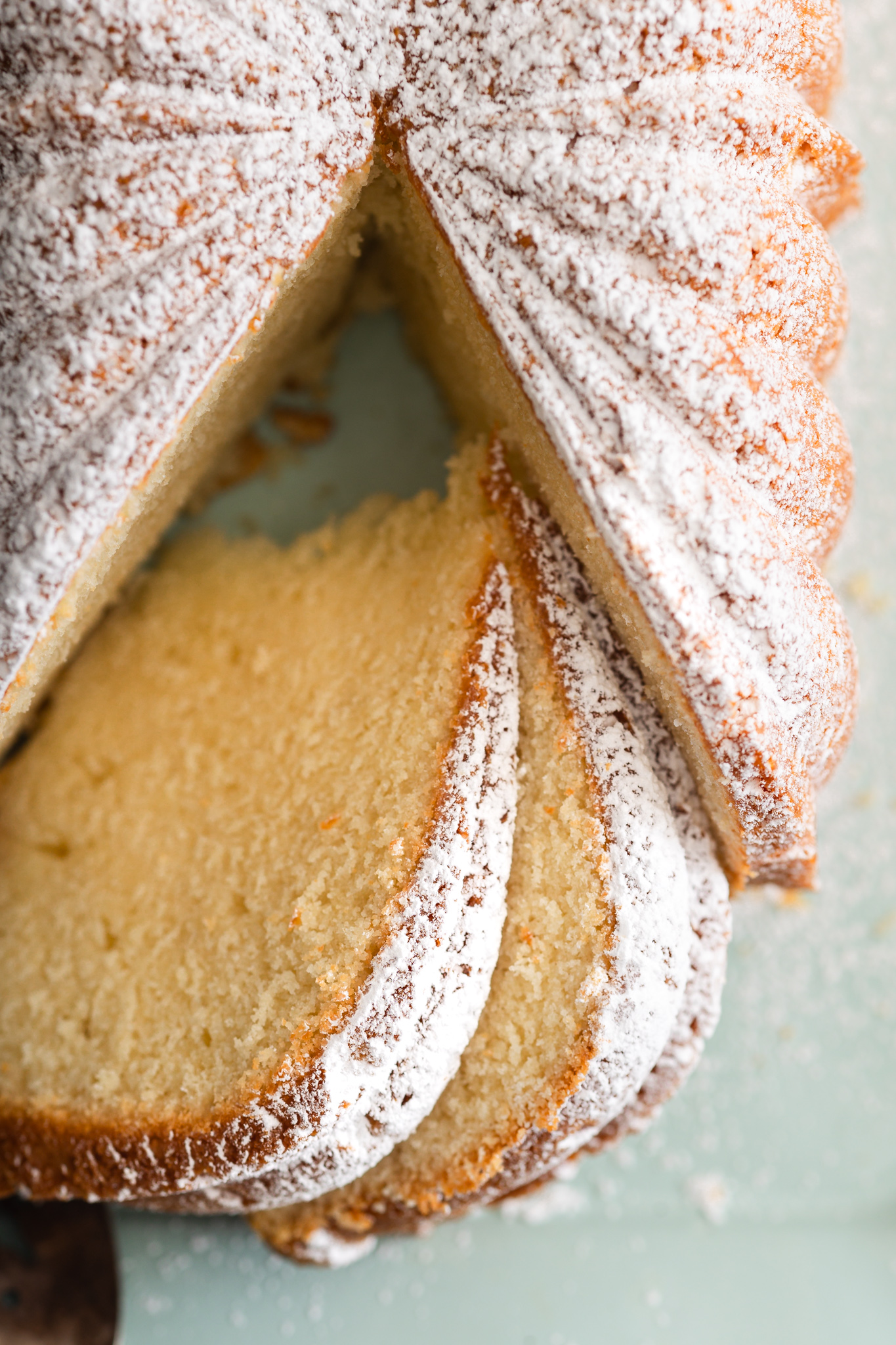 Cream Cheese Vanilla Bean Pound Cake Yield: 1 large 10- to 12-cup Bundt cake Prep Time: 20 minutes Bake Time: About 1 hour 20 minutes Oven Temperature: 325°F Method: Baking Cuisine: American Ingredients 1 cup (2 sticks) butter, softened 1 (8-ounce) package full-fat cream cheese, softened 3 cups granulated sugar 6 large eggs, room temperature 1 tablespoon vanilla bean paste 3 1/2 cups all-purpose flour 3/4 teaspoon baking powder 1/4 teaspoon kosher salt 1 cup heavy whipping cream Baking spray with flour, for preparing the pan Instructions Preheat the oven. Preheat your oven to 325°F. Thoroughly coat a 10- to 12-cup Bundt pan with baking spray containing flour, making sure you get into every nook and cranny. Combine the butter and cream cheese. In the bowl of a stand mixer fitted with the paddle attachment, beat the softened butter and cream cheese together for 1–2 minutes, until completely combined and smooth. Cream with the sugar. Scrape down the sides and bottom of the bowl. Add the granulated sugar and beat on medium-high speed for 3–4 minutes, until the mixture is light, fluffy, and thoroughly creamed. Add the eggs. Scrape down the bowl again—with the mixer turned off, trust me on this one. Add the eggs one at a time on medium speed, mixing until each egg is incorporated before adding the next. Add the vanilla. Mix in the vanilla bean paste until combined. Combine the dry ingredients. In a separate medium bowl, whisk together the flour, baking powder, and kosher salt. Give everything a good whisk to combine the ingredients and add a little air. Begin adding the flour. Add half of the flour mixture to the butter mixture. Mix on low speed just until it's mostly incorporated. Add the cream. Pour in all of the heavy whipping cream and continue mixing on low just until the batter begins to come together. Finish the batter. Add the remaining flour mixture and mix on low only until combined. Don't overmix. Remove the bowl from the mixer and use a spatula to gently stir the batter a few times, making sure anything hiding at the bottom gets incorporated. Fill the pan. Spoon the batter evenly into the prepared Bundt pan. Smooth the top with an offset spatula. Place a folded kitchen towel on the counter and gently tap the pan against it a couple of times to release any large air bubbles. Bake. Bake at 325°F for approximately 1 hour 20 minutes, beginning to check the cake at the 1-hour mark. The cake is done when it's deeply golden and a toothpick inserted near the center comes out clean or with just a few moist crumbs. Cool the cake. Let the cake cool in the pan for 15 minutes. Carefully invert it onto a wire cooling rack. If we did our job with that baking spray, it should release without too much drama. Cool completely. And I mean completely, my friends. Let the pound cake cool all the way before slicing. Serve. Serve it completely plain, hubby-style, or dust it with powdered sugar and add whipped cream, Ivy-and-Mom-style. Either way, it's going to be sooooo good. Notes For the pan: This recipe is sized for a 10- to 12-cup Bundt pan. If you're using a smaller decorative Bundt pan, don't overfill it. Use the extra batter to make a small loaf or another little cake. High-altitude note: This recipe uses a modest amount of baking powder intentionally. At higher elevations, cakes can rise too quickly and collapse before their structure has time to set. Don't overmix: Once the flour goes in, keep the mixer on low and stop as soon as everything is combined. Overmixing develops more gluten and can make your pound cake tougher instead of beautifully tender. Storage: Store the cooled pound cake tightly covered at room temperature for a few days. For longer storage, wrap individual slices well and freeze them so future-you can have pound cake with coffee—which is an excellent gift to future-you.